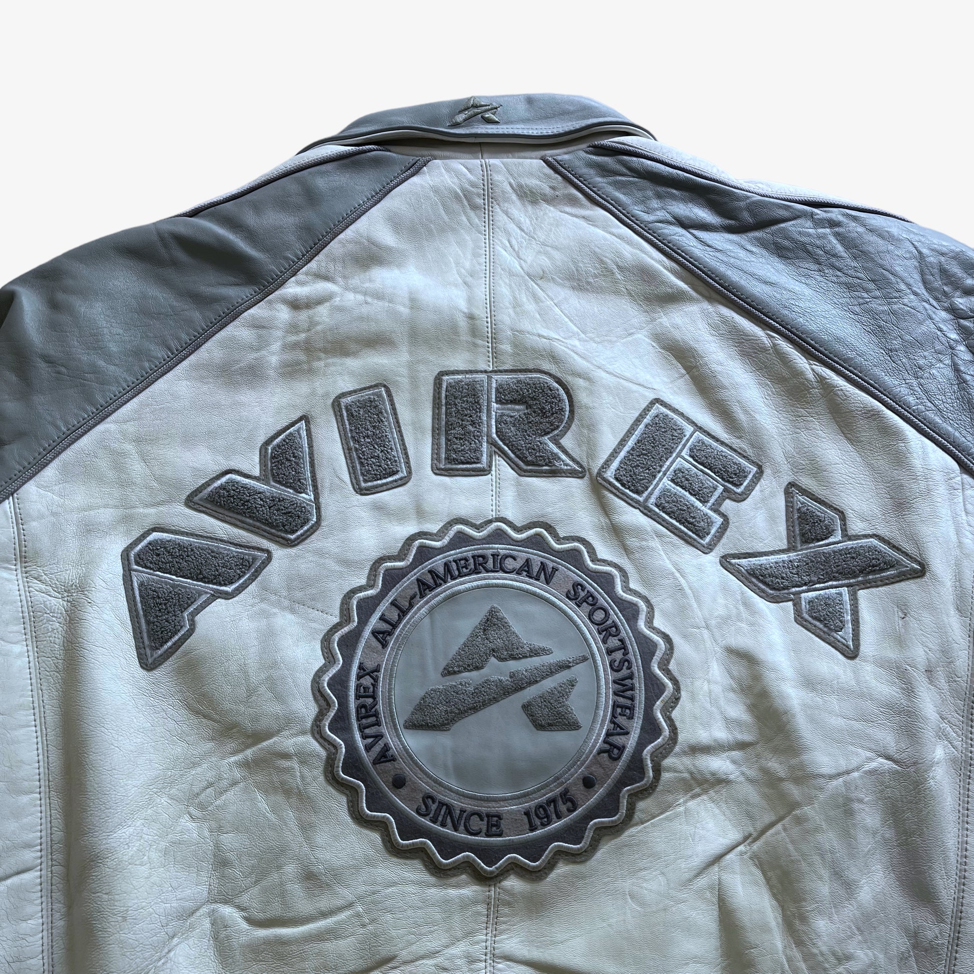 Vintage 90s Mens AVIREX White & Grey Leather Varsity Jacket With Back Embroidered Spell Out Logo - Casspios Dream