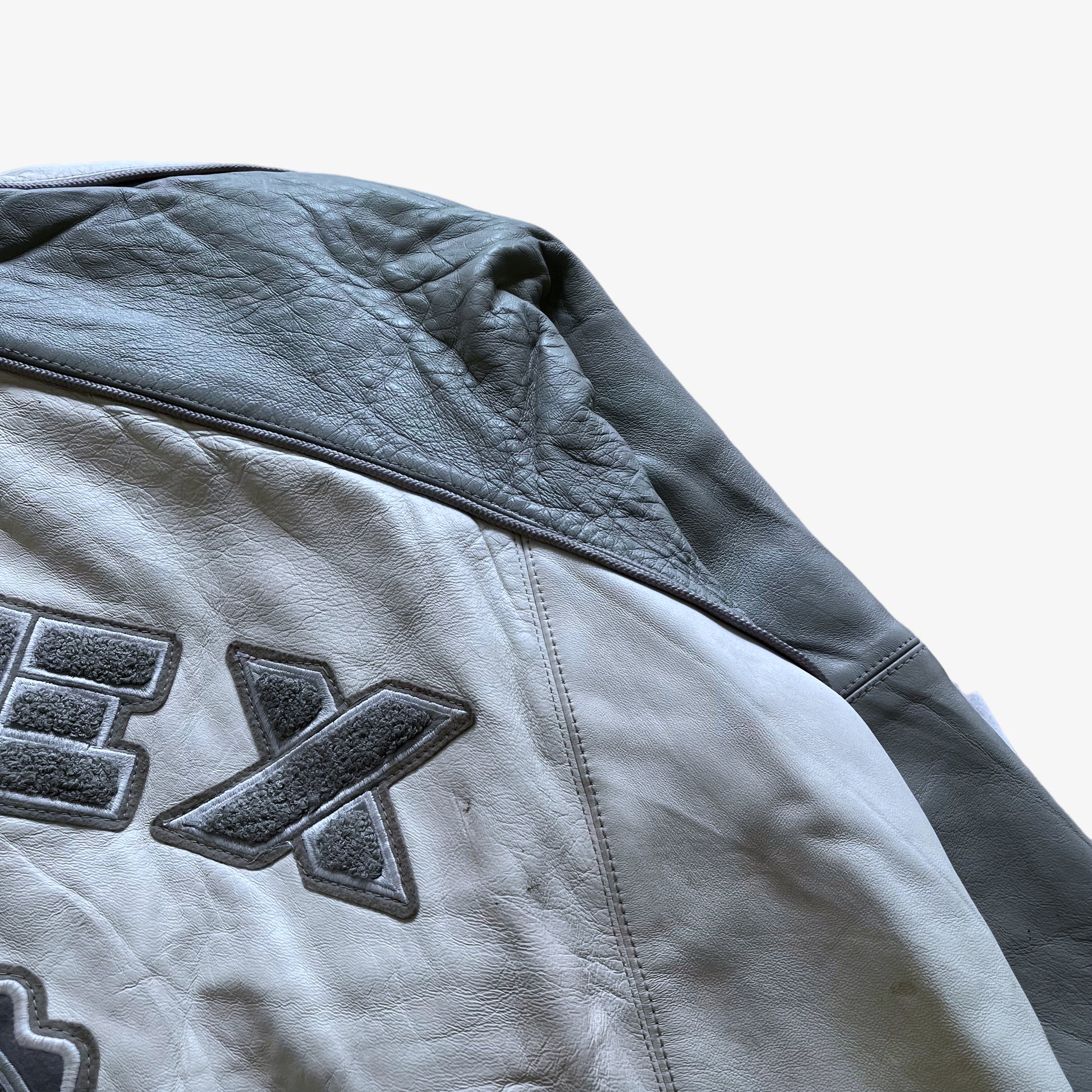 Vintage 90s Mens AVIREX White & Grey Leather Varsity Jacket With Back Embroidered Spell Out Mark - Casspios Dream