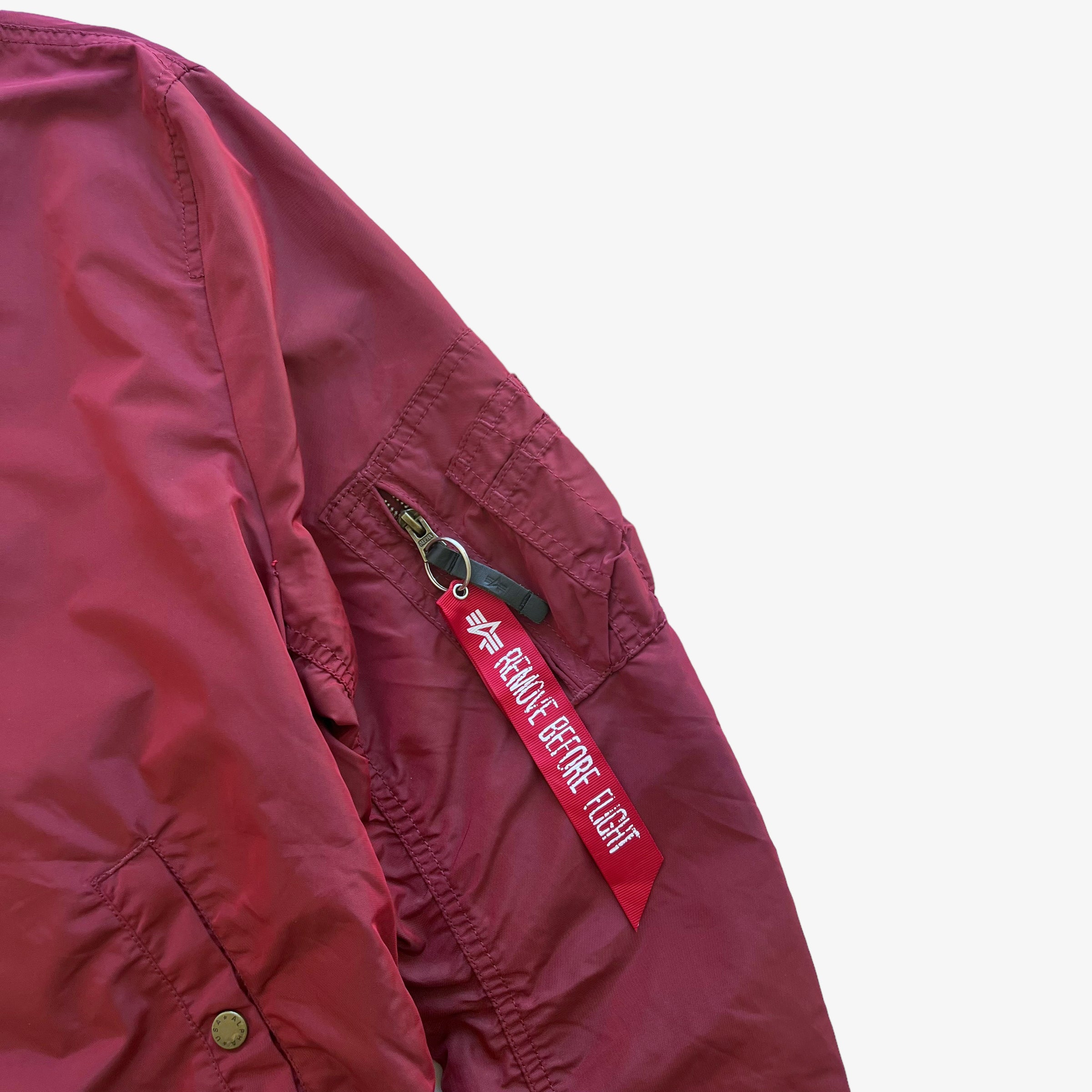 Bomber jacket with red tag on sleeve shop
